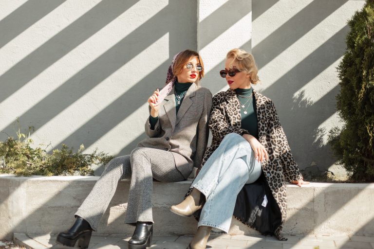 Two beautiful stylish girlfriends of the model in fashionable cl